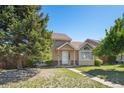 Classic two-story house featuring a cozy front porch, complemented by a well-manicured lawn and landscaping at 21111 E 43Rd Ave, Denver, CO 80249