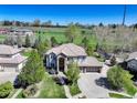Expansive property featuring lush greenery, a spacious driveway, and a well-manicured lawn at 12825 W 81St Ave, Arvada, CO 80005