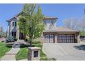 Charming two-story house with a well-maintained lawn, and a convenient three-car garage at 12825 W 81St Ave, Arvada, CO 80005