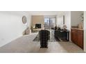 Open living room with fireplace and view to dining area at 1313 N Williams St # 703, Denver, CO 80218