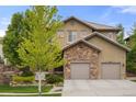 This lovely home features stone accents and a two-car garage, blending elegance with practical design at 14841 W Warren Ave, Lakewood, CO 80228