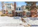 Charming townhouse with brick and siding exterior in a winter setting at 4626 S Dillon Ct # B, Aurora, CO 80015