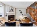 Cozy living room featuring a fireplace and wood staircase at 4626 S Dillon Ct # B, Aurora, CO 80015
