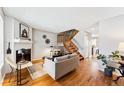 Open-concept living room with hardwood floors and staircase at 4626 S Dillon Ct # B, Aurora, CO 80015