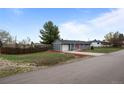 Quaint home featuring a well-kept lawn, attached garage, and a comfortable suburban setting at 7906 S Dover St, Littleton, CO 80128