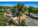 Aerial view of a property with large yard, gravel parking, and neighboring homes at 449 Lowell Blvd, Denver, CO 80204