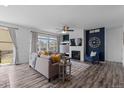 Cozy living room with fireplace and an abundance of natural light creates a warm and inviting atmosphere at 17960 Weymouth Ave, Parker, CO 80134