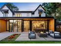 A modern patio includes a fire pit with seating, extending from an open home with glass doors at 346 Elm St, Denver, CO 80220