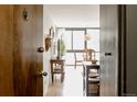 Entryway view showcasing an inviting space with hardwood floors and dining area at 1050 N Corona St # 312, Denver, CO 80218