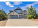 Charming two-story home featuring a stone facade, three-car garage, well-maintained landscaping, and a spacious driveway at 6258 Lancaster Ave, Castle Rock, CO 80104