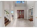 Spacious foyer with a soaring ceiling and elegant tile flooring creates a grand entrance at 5604 Singletree Ln, Parker, CO 80134