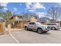 Townhome complex with mature trees, ample parking, and visible accessibility parking space at 7995 E Mississippi Ave # C11, Denver, CO 80247