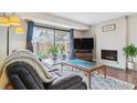 Inviting living room with brick fireplace, sliding glass doors, and comfortable seating arrangement at 7995 E Mississippi Ave # C11, Denver, CO 80247