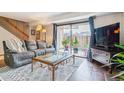 Comfortable living room with a large sliding glass door, opening to a small outdoor patio at 7995 E Mississippi Ave # C11, Denver, CO 80247