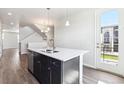 Kitchen island with double sink, modern faucet, and stainless steel dishwasher, adjacent to outdoor access at 457 Interlocken Blvd # 101, Broomfield, CO 80021