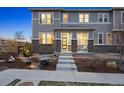 Inviting townhome showcasing a modern front door, stone accents, and a welcoming front porch at 7257 S Millbrook Ct, Aurora, CO 80016