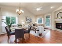 Bright living room featuring hardwood floors, fireplace, and lots of natural light at 8255 E 150Th Pl, Thornton, CO 80602