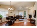 Inviting living room featuring hardwood floors, a fireplace, and stylish decor with ample seating at 8255 E 150Th Pl, Thornton, CO 80602