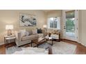 Inviting living area with neutral tones, comfortable seating, and large windows at 8255 E 150Th Pl, Thornton, CO 80602