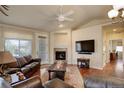 Comfortable living room with a fireplace, hardwood floors, and a large TV, perfect for entertaining at 8255 E 150Th Pl, Thornton, CO 80602
