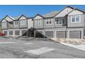 Gray townhouses with attached garages and mountain views at 31191 Black Eagle Dr # 102, Evergreen, CO 80439