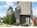 Attractive townhome featuring a private balcony and a stylish facade with stone accents near the entry at 4922 Lowell Blvd # 2, Denver, CO 80221