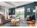 Open concept living room with a view to the balcony, comfortable seating, and urban-chic accents at 4922 Lowell Blvd # 2, Denver, CO 80221