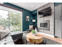 Stylish living room with a modern fireplace, sleek furniture, and a large window showcasing outdoor views at 4922 Lowell Blvd # 2, Denver, CO 80221