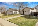 Inviting single-story home boasting a two-car garage, lush lawn and sidewalk at 20630 E Ithaca Pl, Aurora, CO 80013