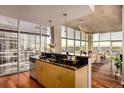 Modern kitchen with stainless steel appliances and a breakfast bar overlooking the living area at 1700 Bassett St # 2117, Denver, CO 80202