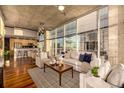 Sun-filled living room open floor plan, floor-to-ceiling windows, and stylish modern decor at 1700 Bassett St # 2117, Denver, CO 80202