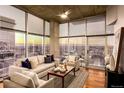 A modern living room with floor-to-ceiling windows offering panoramic city views at 1700 Bassett St # 2117, Denver, CO 80202