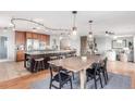 Gourmet kitchen with large island, stainless steel appliances, granite countertops, and a dining area at 5761 W 50Th Ave, Denver, CO 80212