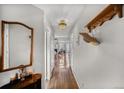 Inviting hallway with wood floors and coat rack leads to living spaces with great natural light from front windows at 1865 S Union Blvd, Lakewood, CO 80228