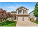 Beautiful two-story house featuring a stone-accented facade, covered porch, and a spacious two-car garage at 9928 Sylvestor Rd, Highlands Ranch, CO 80129