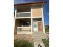 Exterior view showing a private balcony, red brick detail, and covered entry at 11644 Community Center Dr # 126, Northglenn, CO 80233