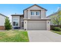 Charming two-story home with a well-maintained front yard, attached two-car garage and covered front porch at 10512 Hyacinth St, Highlands Ranch, CO 80129