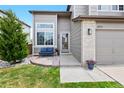 Inviting front entrance with charming brick accents and a cozy seating area, enhancing curb appeal at 10512 Hyacinth St, Highlands Ranch, CO 80129