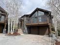 Beautiful exterior of a brown home featuring a stone facade and attached two-car garage at 19 South Rd, Breckenridge, CO 80424