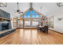 Bright living room featuring vaulted ceilings, stone fireplace, hardwood floors, and large windows at 19 South Rd, Breckenridge, CO 80424