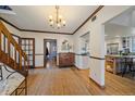 Bright entryway with hardwood floors, staircase, and view of kitchen at 4401 S Lincoln St, Englewood, CO 80113