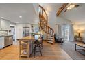 Modern kitchen with island, stainless steel appliances, and spiral staircase at 4401 S Lincoln St, Englewood, CO 80113