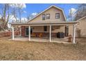 Covered patio with seating area, grill, and backyard access at 4401 S Lincoln St, Englewood, CO 80113