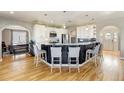 Open kitchen featuring a large island with bar seating, white cabinets, and stainless steel appliances at 5895 E Conservation Dr, Frederick, CO 80504