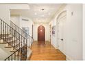 Elegant foyer with hardwood flooring, curved staircase, and decorative chandelier at 958 S Columbine St, Denver, CO 80209