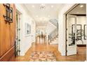 Grand foyer showcasing hardwood floors, staircase, and views into the dining room at 958 S Columbine St, Denver, CO 80209