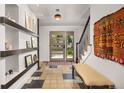 Welcoming foyer with decorative tile flooring, stylish light fixture, and staircase at 1579 W Costilla Pl, Littleton, CO 80120