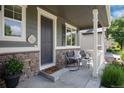 Inviting front porch with stone accents, offers a cozy seating area perfect for enjoying the outdoors at 3027 Walnut Grove St, Erie, CO 80516
