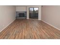 Spacious living room features stylish floors, fireplace, and balcony access for modern comfort and relaxation at 7255 E Quincy Ave # 205, Denver, CO 80237