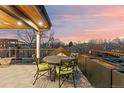 Relax on this beautiful rooftop deck with a dining table and amazing views during sunset at 354 Milwaukee St, Denver, CO 80206